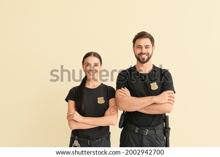 Police officers on color background