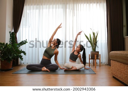 Healthy family mother and little girld practic yoga at home, new normal lifestyle, new normal helphty liftyle at home 