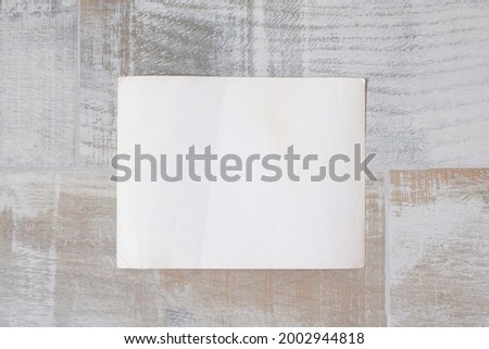 Blank empty photograph paper page with copy space on the floor flat lay background.