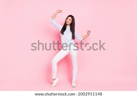 Full length body size of cheerful woman dancing at party looking copyspace isolated on pastel pink color background