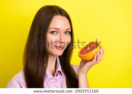 Photo portrait young woman keeping grapefruit eat healthy food isolated vibrant yellow color background