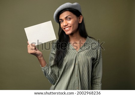 Transgender woman showing a blank white card with design space