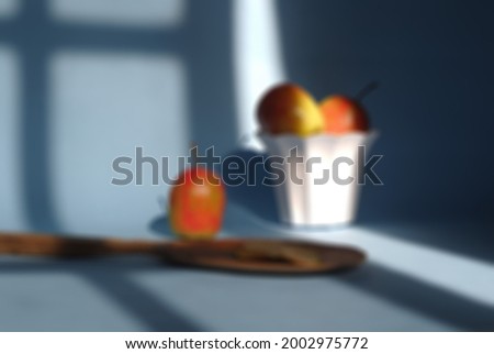 Blur photo of fresh apples on blue and pink background