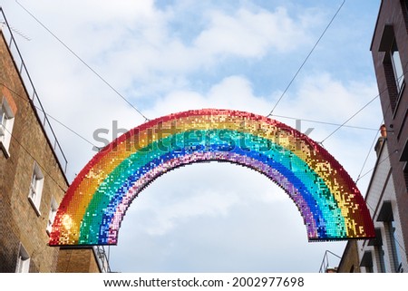 A rainbow coloured sequins decoration hanging above the street, a symbol of LGBT and good fortune