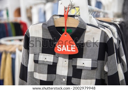 sale sign with clothes in shop
