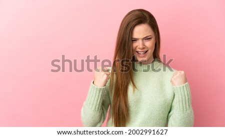 Teenager girl over isolated pink background frustrated by a bad situation