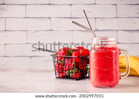 Strawberry smoothie or cocktail in the glass jar