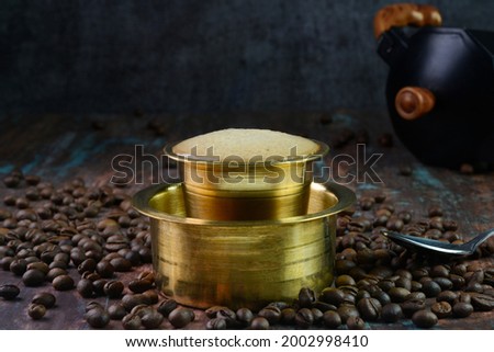 Filter coffee served in a brass cup Royalty-Free Stock Photo #2002998410