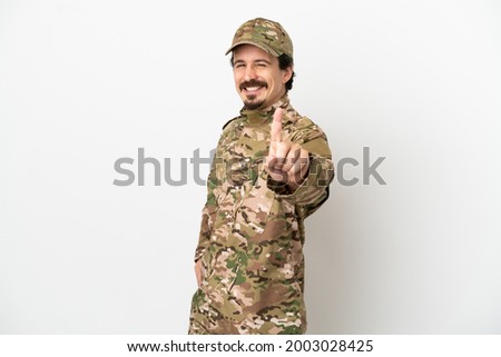 Soldier man isolated on white background showing and lifting a finger