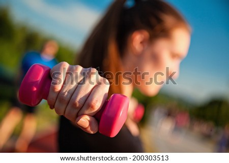 Attractive Young Woman Working Out With Dumbbell