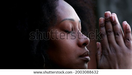 African woman praying to God asking for spiritual guidance