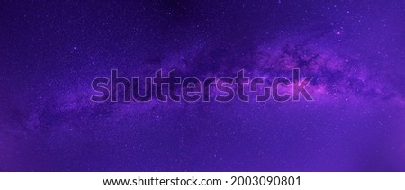 Panorama purple  night sky milky way and star on dark background.Universe filled with stars, nebula and galaxy with noise and grain.Photo by long exposure and select white balance. 