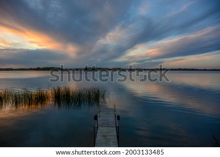 Clouds reflections and beautiful colors of a tranquil sunset at North Turtle Lake in Minnesota
