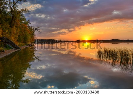 Clouds reflections and beautiful colors of a tranquil sunset at North Turtle Lake in Minnesota
