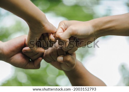 World environment day with global community teamwork, Group of volunteers joins the hand together concept, Volunteer charity work. People joining for cooperation success. sustainable development goal Royalty-Free Stock Photo #2003152793