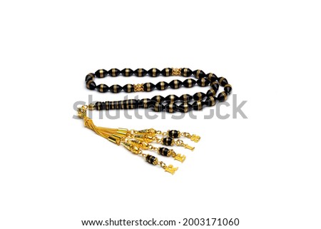 Muslim prayer beads on a white background. Black beads with gold details. Tasbeeh, Muslim Misbaha, Salah Prayer Beads. Suitable for gift too. Royalty-Free Stock Photo #2003171060
