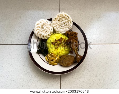 A picture of turmeric rice with lots of dishesh from top angle