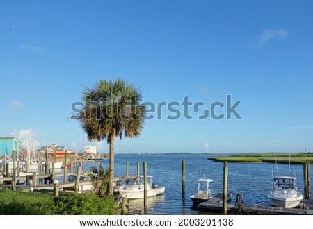 View of Southport NC riverfront with boat docks and seafood restaurants                                Royalty-Free Stock Photo #2003201438