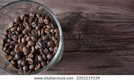coffee beans on the wood texture background vintage color. free space for text on right.
