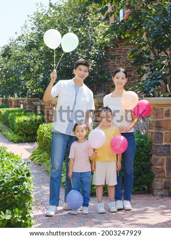 Happy family of four in the outdoor group photo high quality photo