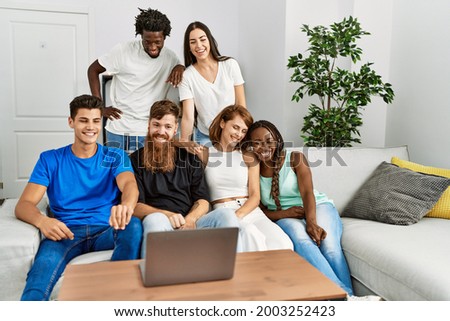 Group of young friends smiling happy having video call using laptop at home.