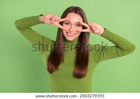 Photo portrait happy woman showing v-sign gesture both hands isolated pastel green color background