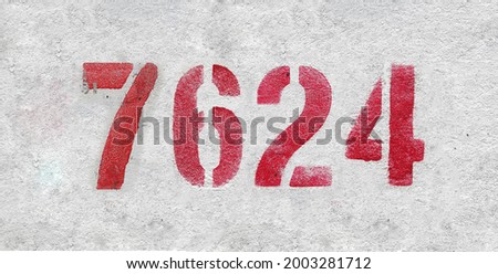 Red Number 7624 on the white wall. Spray paint. Number seven thousand six hundred and twenty four.