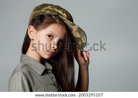 child girl wear military uniform. kid dressed like a soldier