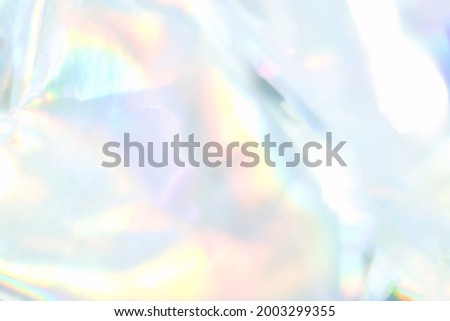 holograph foil background. Pastel color paper. Retro trend design. Vintage fantasy cover. Chrome holo art. Modern effect. Rainbow metallic material. Fabric glitch Royalty-Free Stock Photo #2003299355