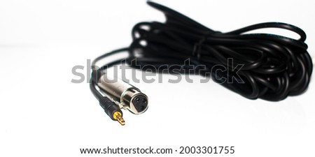 Heap of microphone wire black color wire isolated on a white background.Wire with focusable wire head.Stereo jack