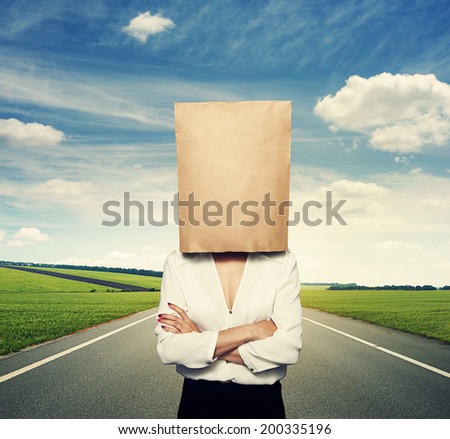 businesswoman hiding under paper bag at outdoor