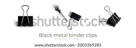 Black metal binder clips isolated on white background. High quality photo