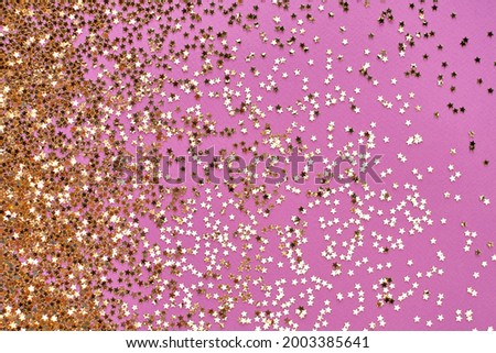 Party flat lay with shining confetti stars shape on pink background