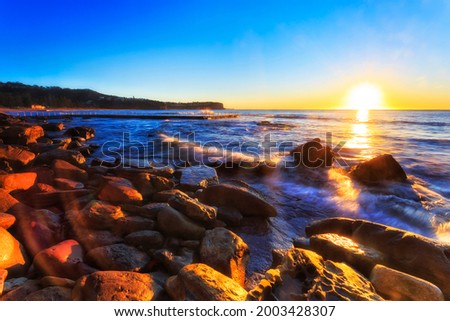 Scenic colourful sunrise at Newport beach of Sydney Northern beaches in Australia - Pacific ocean seascape.