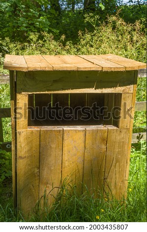 a wooden box shaped bin store