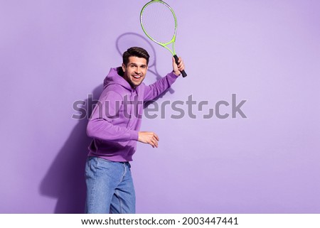 Photo portrait man playing tennis in hoody on court isolated pastel violet color background