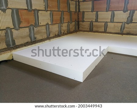 Sheet of expanded polystyrene on the concrete floor for house thermal insulation during constructions Royalty-Free Stock Photo #2003449943