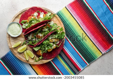 Mexican national food - taco wheat beetroot tortilla with vegan chickpea balls and vegetables                            