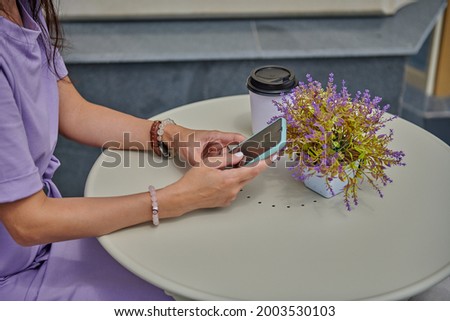business woman in a cafe sitting with a phone