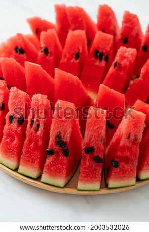fresh watermelon sliced on wooden plate