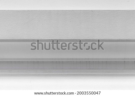 Vintage white painted cement wall with rough surface texture and background seamless