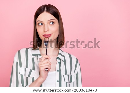 Photo of young girl happy positive smile lick fork dream look empty space hungry dish isolated over pastel color background