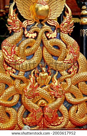 Detail of the golden statue Naga in temple 