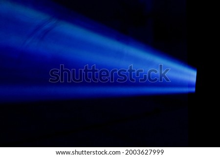 Blue projector light in the dark
