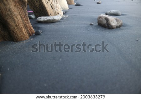 The black beach sand and beach stones that we took pictures of on the dodol rock beach in Banyuwangi City