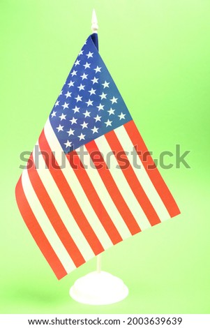 American flag on a green background.