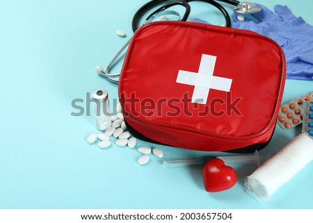 First aid medical kit on blue background
