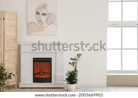 Stylish fireplace in interior of living room
