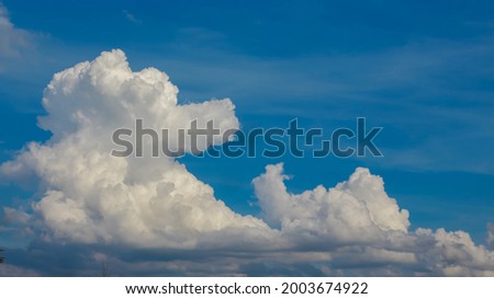 white clouds floating against the blue sky