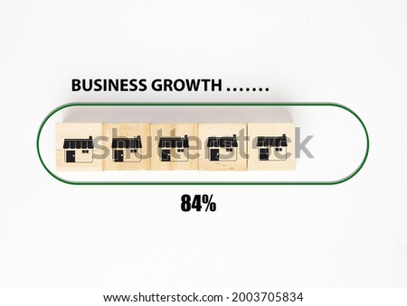 A picture of shop symbol at wooden block, business growth word, loading and progress symbol.